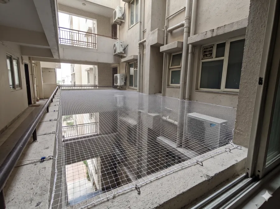Close-up of a neatly tensioned balcony bird net fixed at a corner